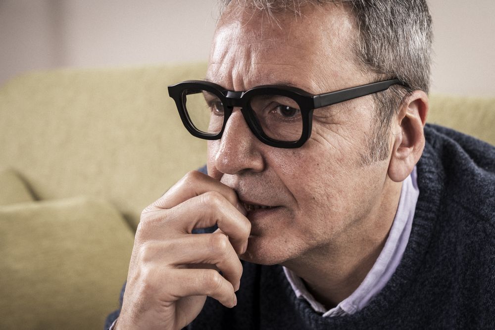 Close-up of an anxious mature man biting his nails.