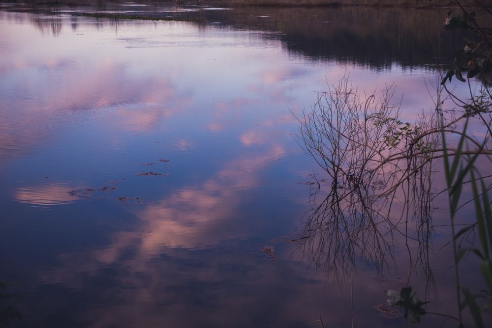 Cloudy evening sky over calm lake