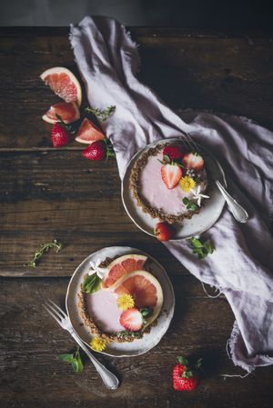 Strawberry and citrus cake served on wooden table