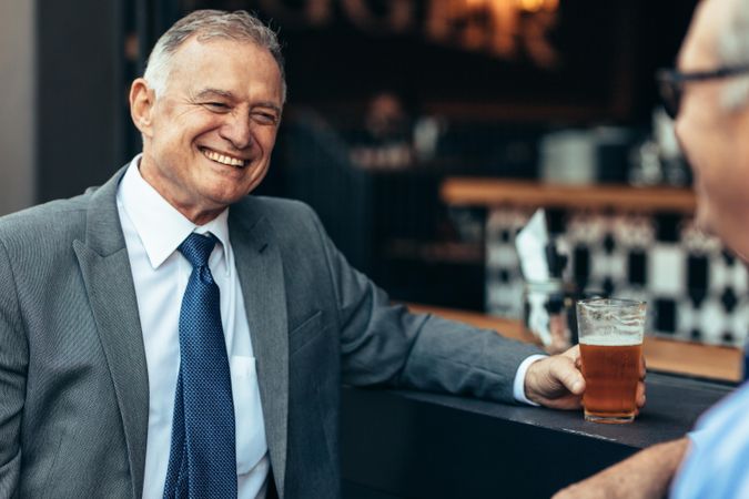 Businessman relaxing at bar after work with colleague