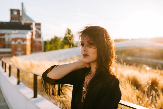 Trendy female standing on urban background