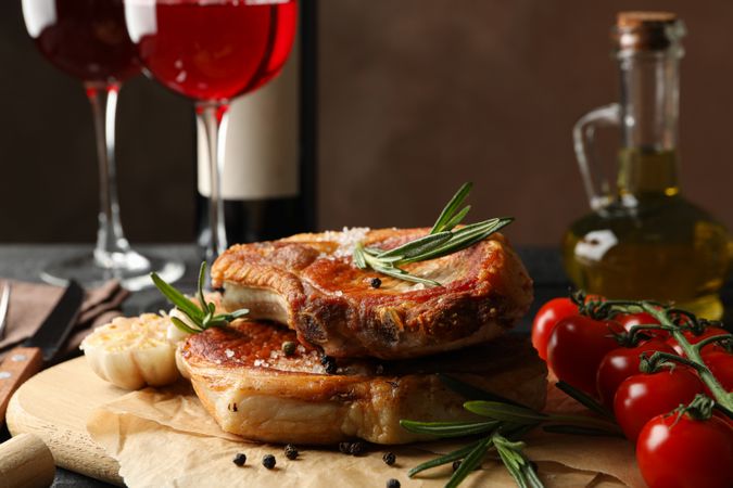 Composition with fried steaks and wine. Grilled food