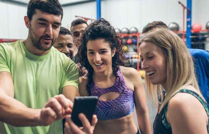 Athletes looking at the mobile of a gym mate