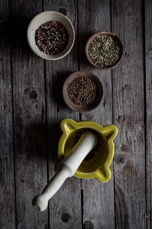 Spices and mortar on wooden table