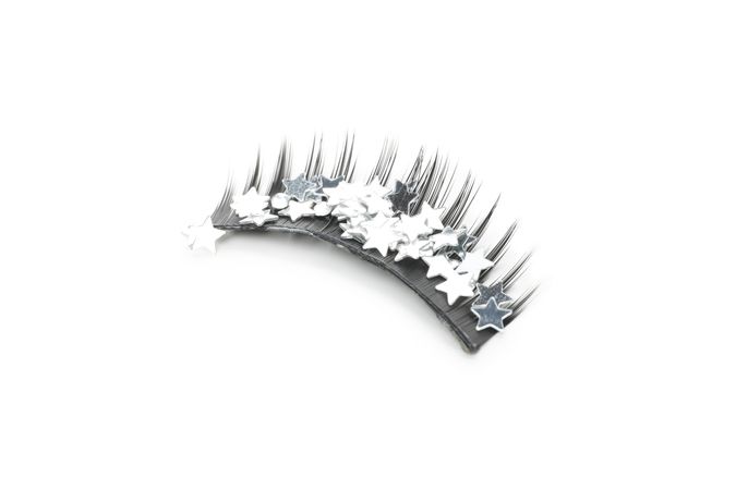 Concept of cosmetology tools, false eyelashes, isolated on light background