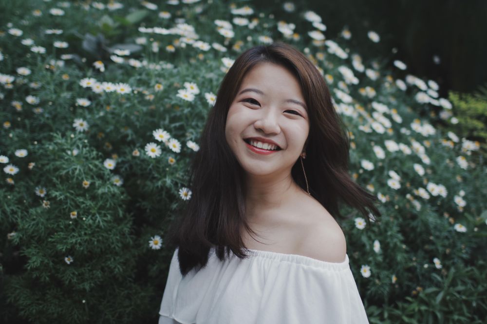 Smiling girl in light off shoulder top