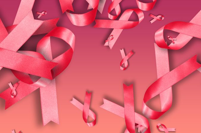 Scattered pink ribbons on pink background