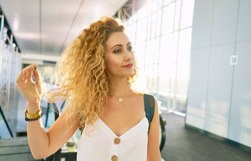 woman walking in spacious hall in sunlight