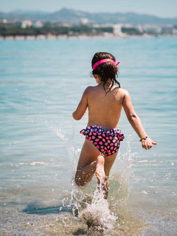 Cheerful girl having fun in warm sea
