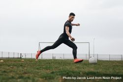 Soccer player in position to kick a football bDZlA5