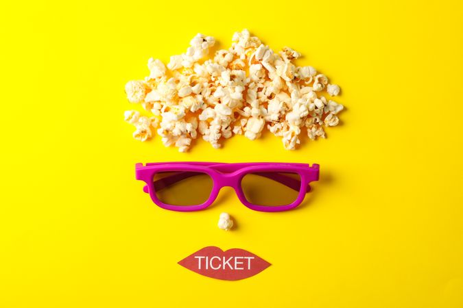 Flat lay composition with movie watching accessories on yellow background, top view
