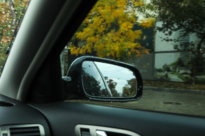 Rearview mirror of a car in rainy weather