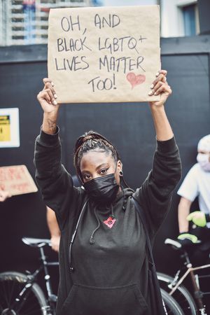 London, England, United Kingdom - June 6th, 2020: Woman with inclusive LGBTQIA sign at BLM protest