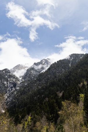 Rocky mountains covered with snow on sunny day