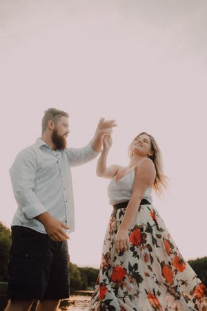 Loving couple standing ankle deep in water on beach