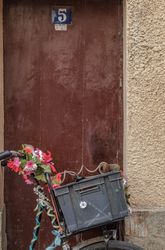 Plastic basket attached to decorative bike, vertical