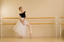 A ballet dancer poses elegantly in a studio
