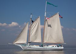 Joshua The Classic Wooden Schooner floating on calm waters in Mobile Bay, Alabama R5R3B4