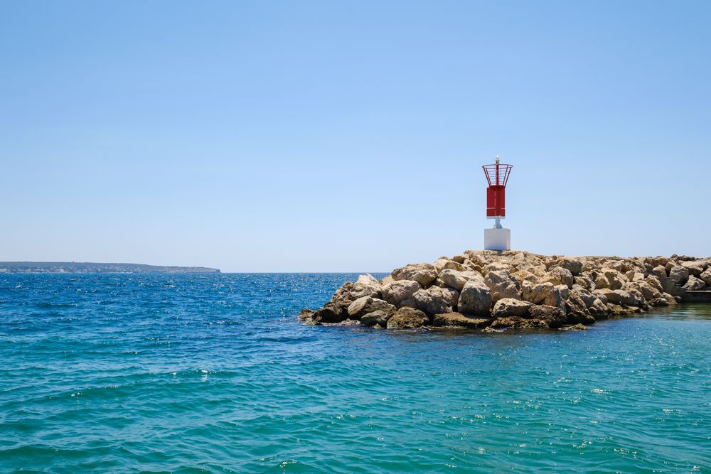 Small lighthouse on seashore