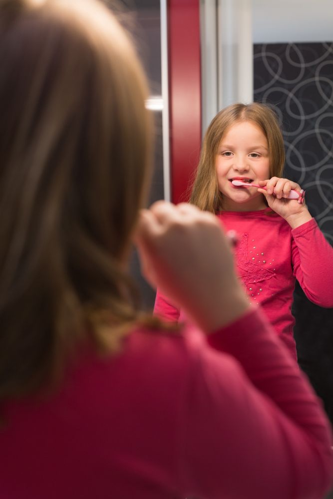 Cute girl brushing her teeth