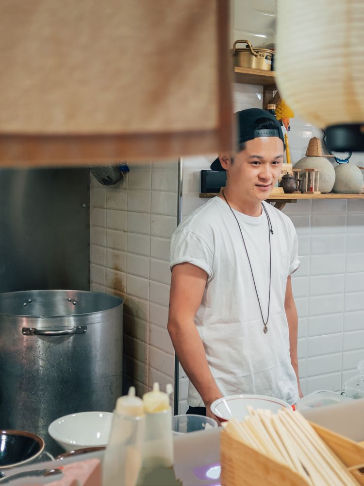 Asian male cook standing in kitchen