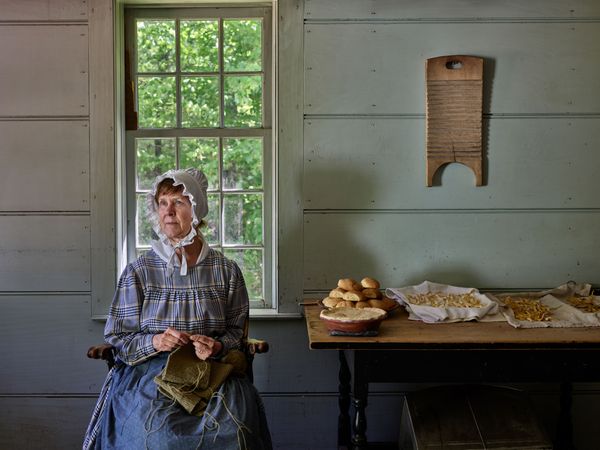 Costumed interpreter knitting at Old Sturbridge Village, Sturbridge, Massachusetts