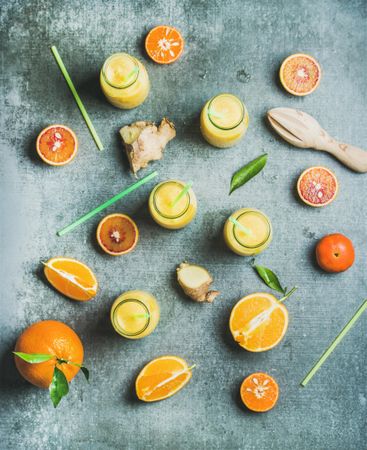 Top view of citrus fruit and juice with ginger