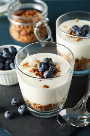 Composition with parfaits desserts on dark blue background, closeup