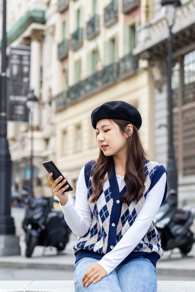 Young Asian woman using smartphone in the city