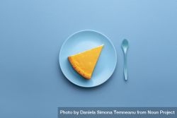 Cheesecake slice on blue plate 48Z670