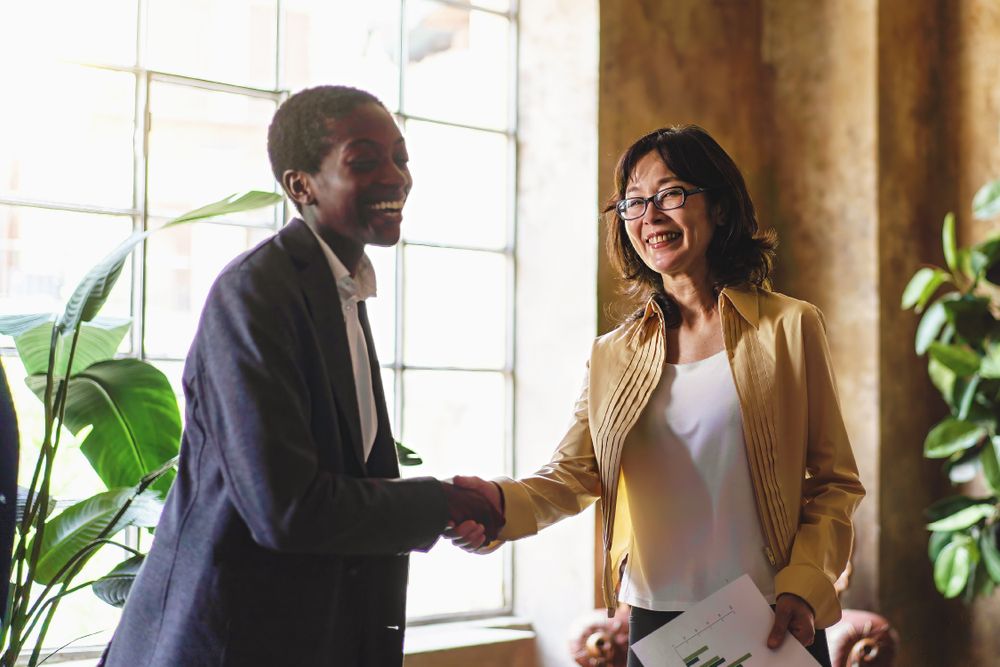 Diverse colleagues bonding in an office handshake