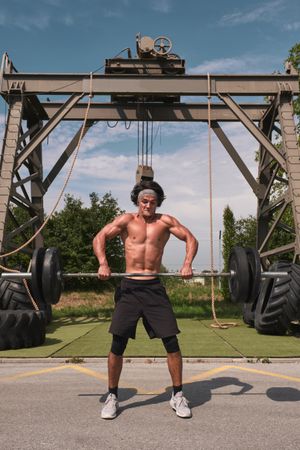 male with barbell in outdoor gym