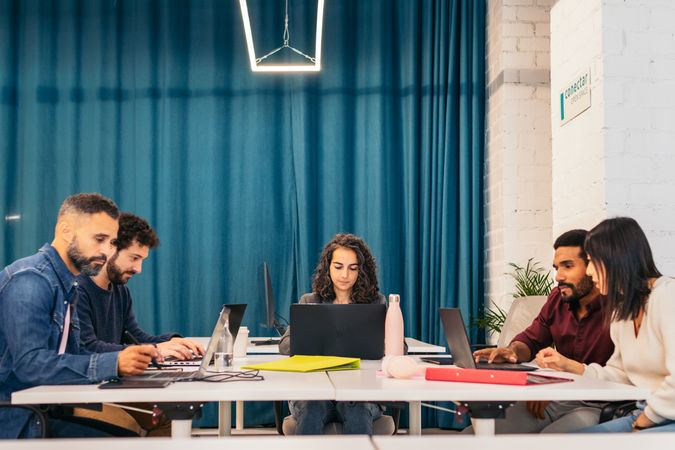 Group of people working with laptop in a coworking