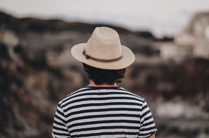 Bearded male in hat on deserted road