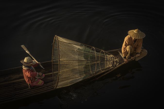 Two fishermen on boat in Myanmar