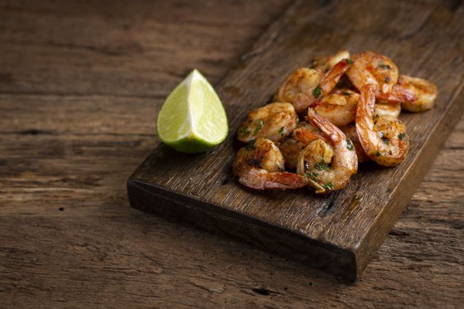 Delicious grilled prawns on wooden background.