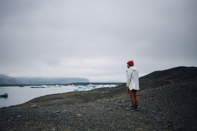 Man standing on coast on overcast day, landscape