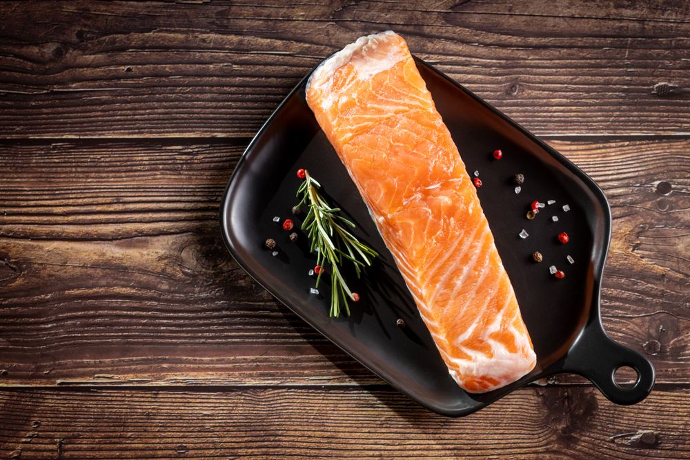 Fresh raw salmon fillet with ingredients for preparation