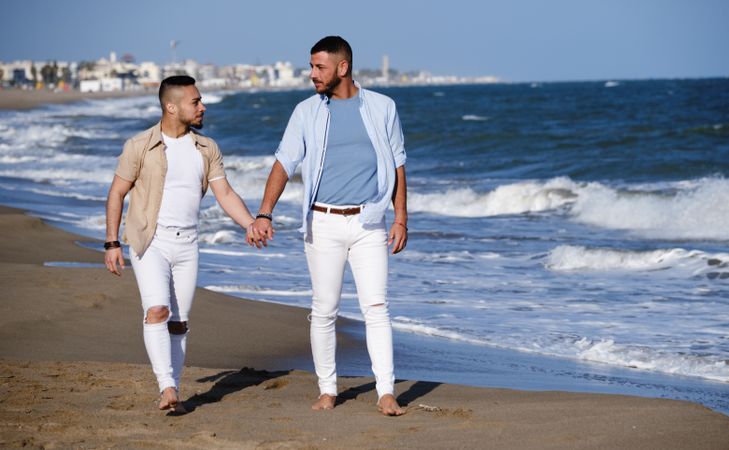 Gay couple walking on beach