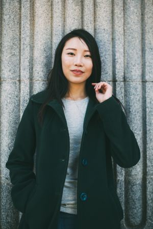 Asian woman near marble wall