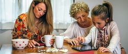 Three female generations using tablet and smartphone