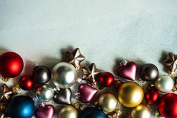 Christmas card concept of colorful baubles on concrete counter with copy space