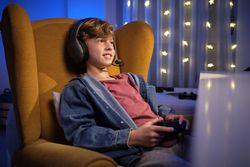 Boy in headphones playing videogame