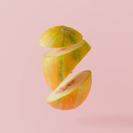 Sliced melon on pastel pink background