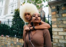 London, England, United Kingdom - August 28, 2022: Female friends embracing on street