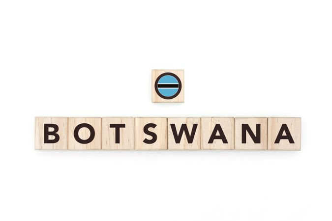 Wooden blocks bearing the name and flag of Botswana. Batswana and South African Culture, national identity, travel, and geography in a copy space design.