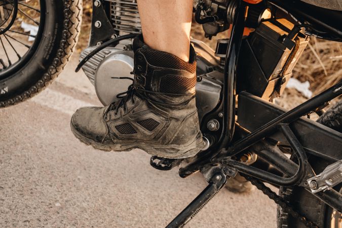 Male riding moto on asphalt