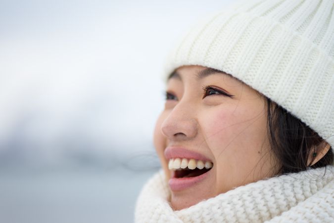 Joyful young woman in warm clothes