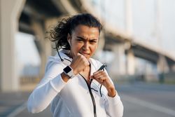 Female boxer practicing punches outdoors