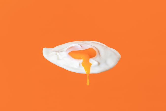 Fried egg isolated on an orange background